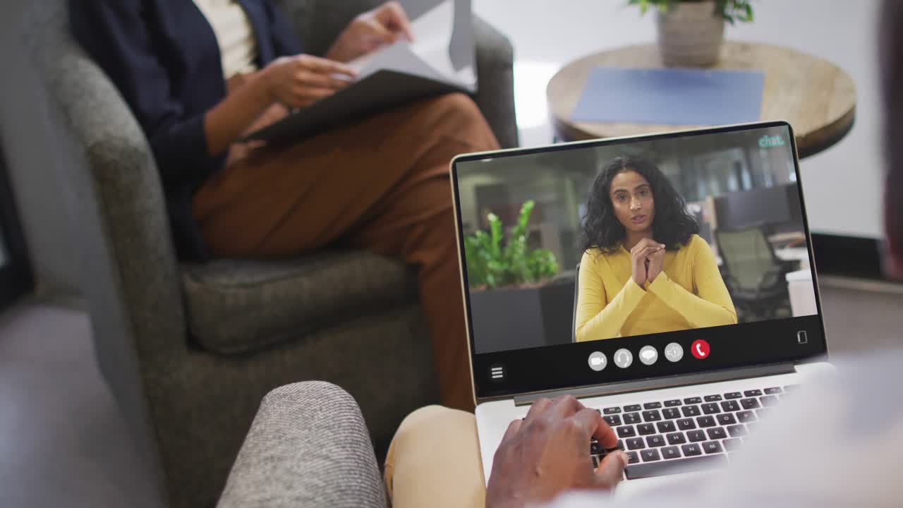African american man using laptop for video call, with business colleague on screen