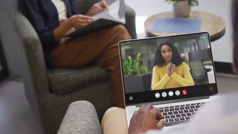 African-american-man-using-laptop-for-video-call,-with-business-colleague-on-screen