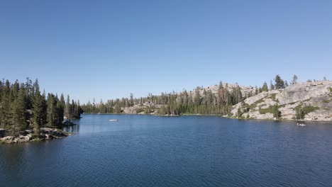 aerial fly over alpine lake mountains