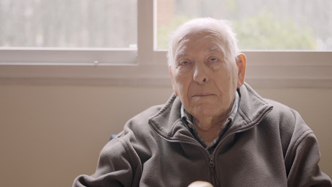 Aged man looking serious sitting on a geriatric