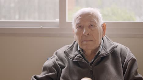 aged man looking serious sitting on a geriatric