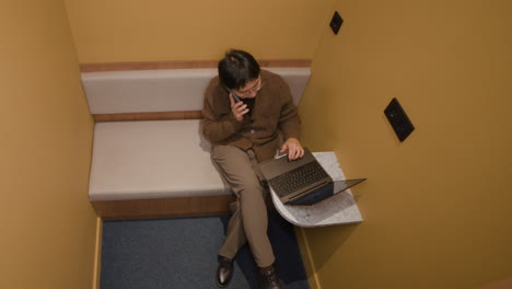 person working in a booth