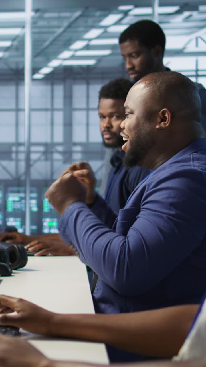 Vertical video Happy data center employee pleased after successfully installing cybersecurity