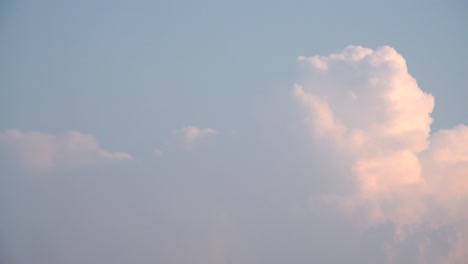 un lapso de tiempo de nubes cumulus nimbus que se construyen rápidamente sobre un fondo de cielo azul al atardecer temprano