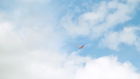 colorful kite soaring in a cloudy sky