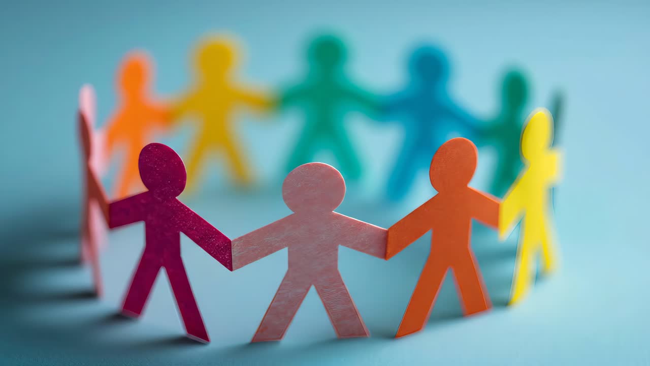 Colorful paper figures holding hands