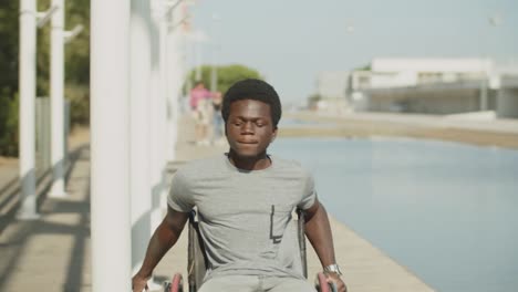 happy african american man wheeling among pylons in park