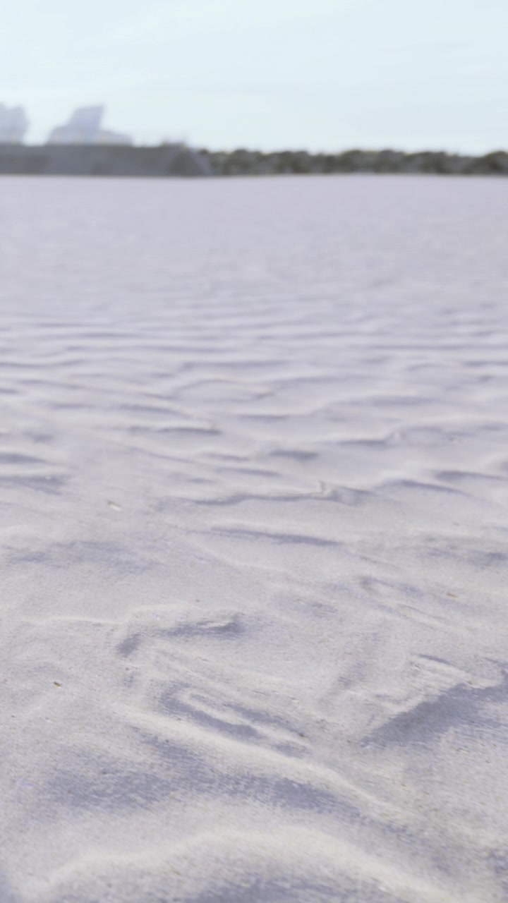Sand surface with gentle patterns in a dry area during sunny weather