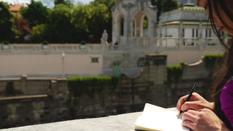 asian woman standing on bridge, writing in her book, vienna - slow motion