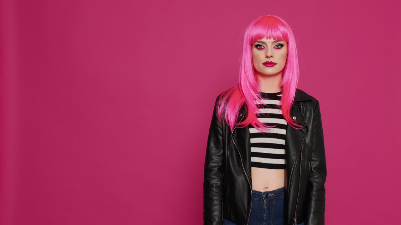 Stylish happy woman pointing up with fingers in studio