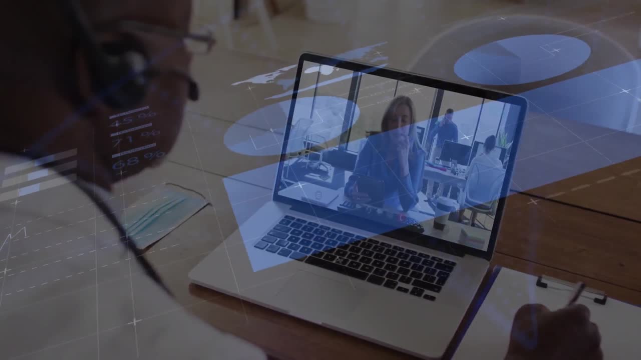 Animation of data processing against african american man having video call on laptop at office