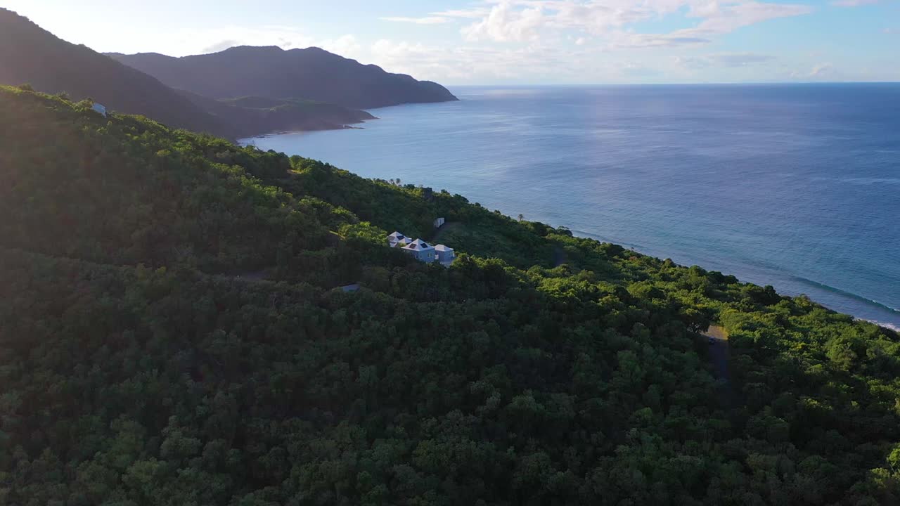 Gliding over the Caribbean Sea near St. Croix, USVI, this drone video shows crystal-clear waters and a select few luxury retreats discreetly hidden within the coastal forest