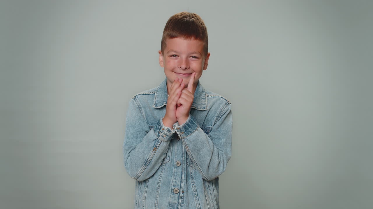 Sneaky cunning boy with tricky face scheming evil plan, thinking over villain idea, jokes, pranks