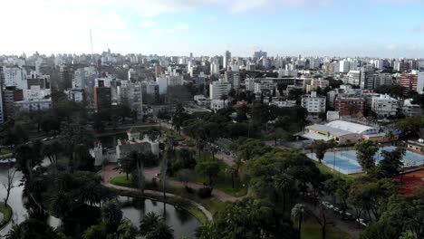aerial-view-of-the-city,-the-castle-and-the-lake-from-the-park-Montevideo,-Uruguay