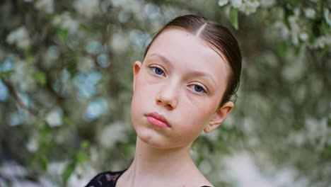 portrait of a young ballerina in a spring garden