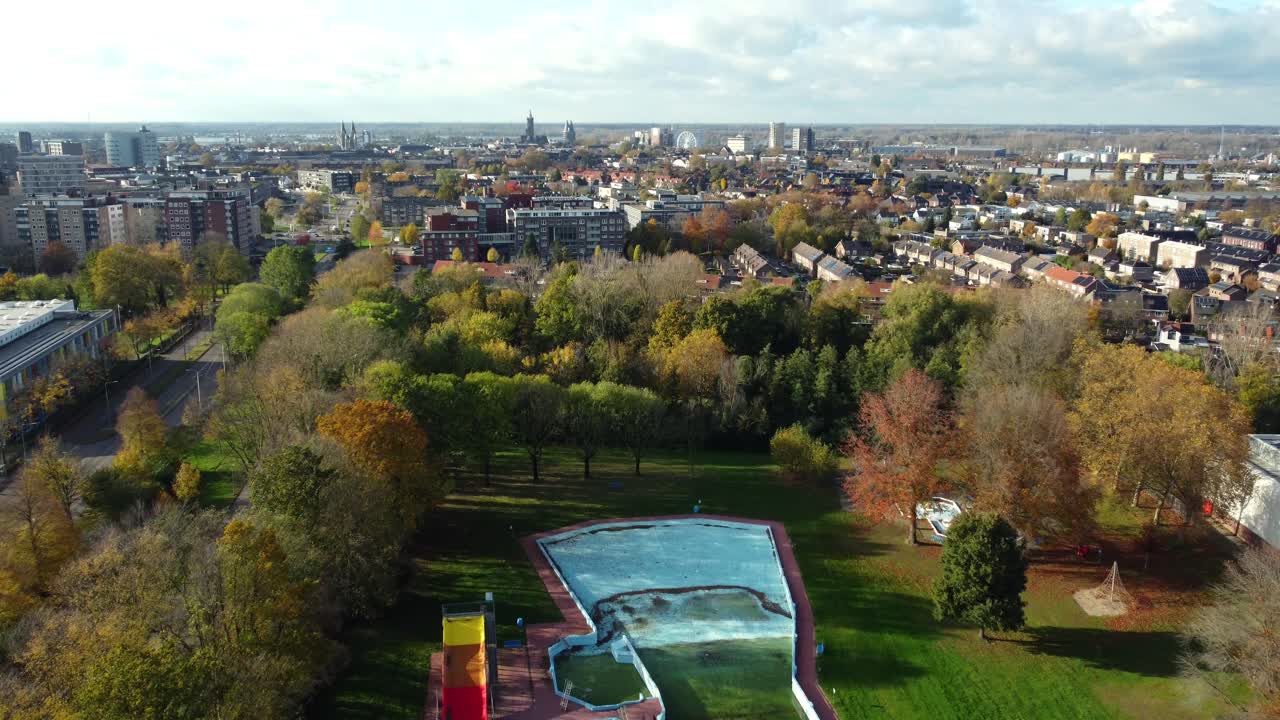 Aerial view of a city with autumn trees and buildings