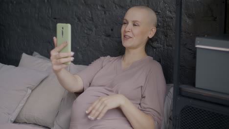 pregnant woman taking a selfie video call