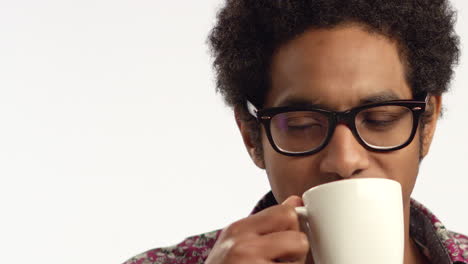 cu young man drinks tea from a mug