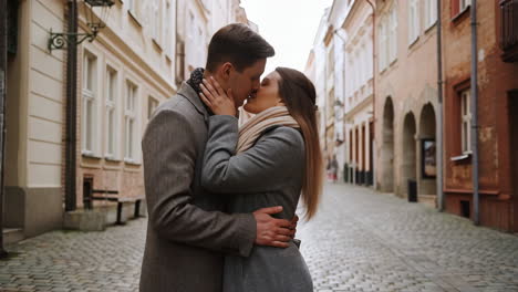 romantic couple kissing on a cobblestone street