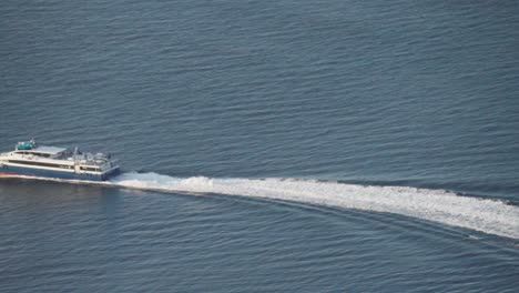 ferry boat with tourists cruising in the fjord in summer in lovund, norway