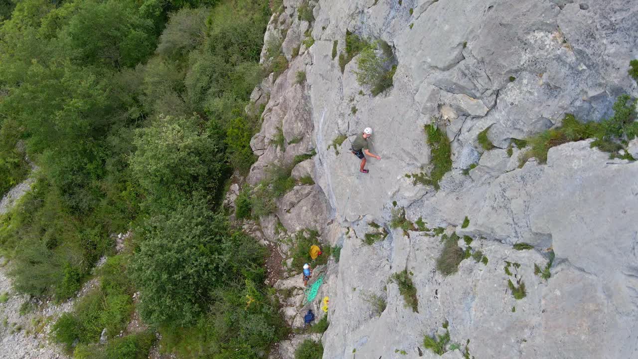 Distant top-down drone footage of a man lead climbing in the Pyrenees moutains at Tarascon sur Ari&egrave;ge