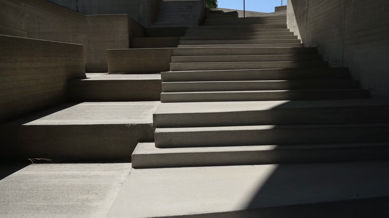 Concrete Steps Bathed In Stark Sunlight Reveal Sharp Geometric Shadows Across Brutalist Stairwell, Minimal