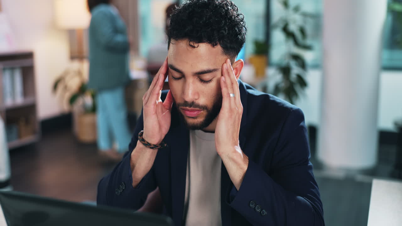 Man experiencing headache in the office