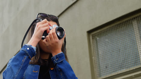 Woman-clicking-photo-with-digital-camera-in-street-4k