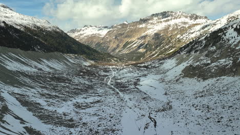 drone dolley shot of the morteratsch valley covered with snow in the swiss alps