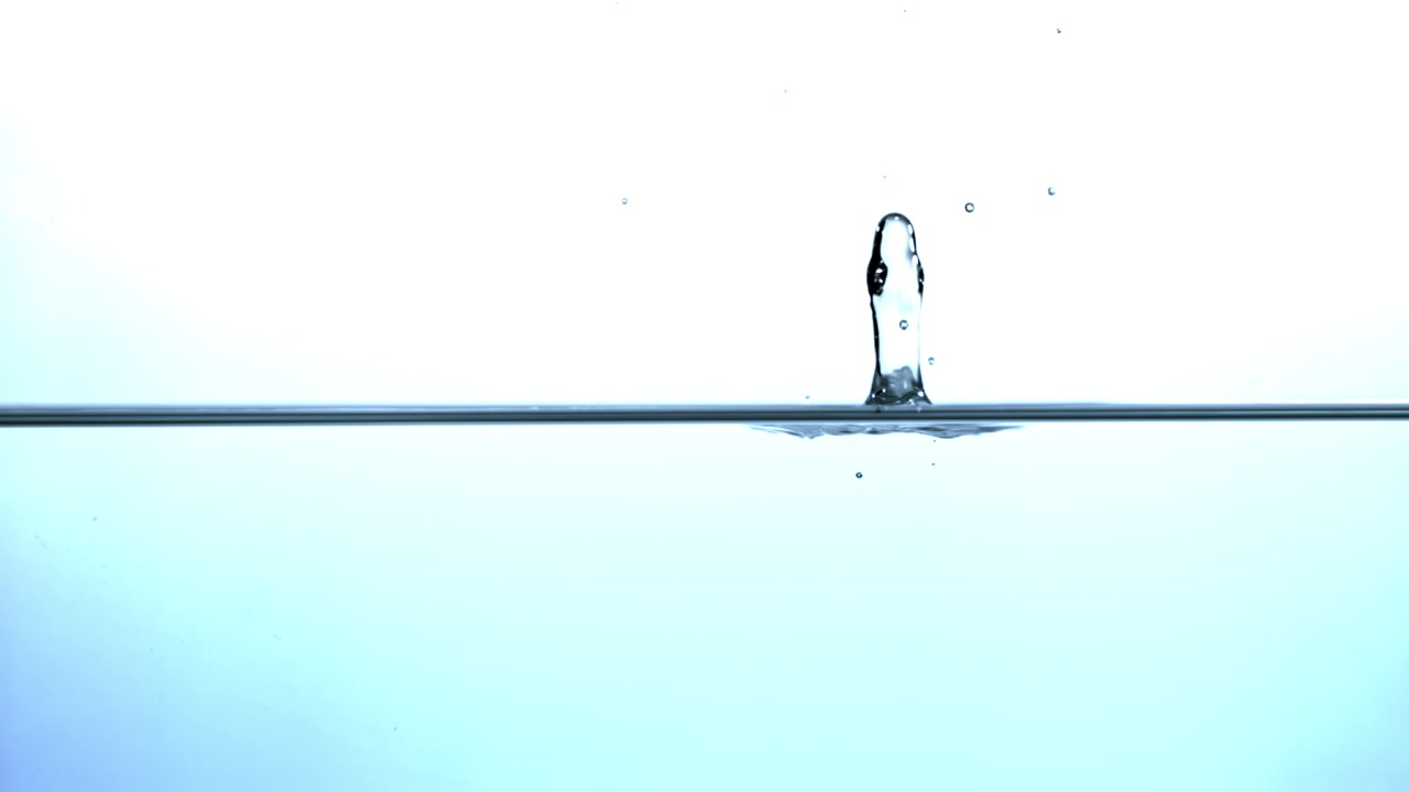 A Single Water Drop Falling into Clear Water in Slow Motion