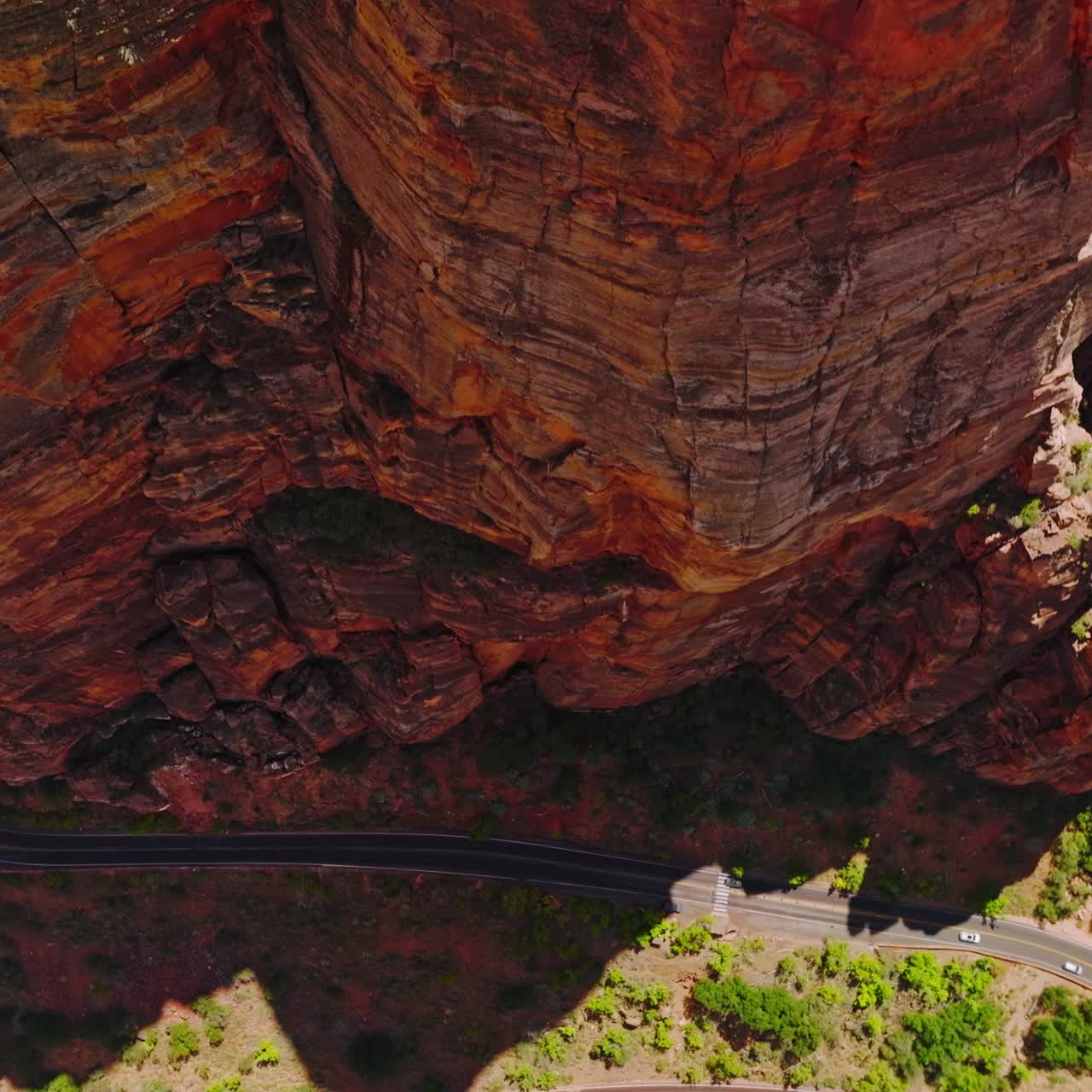 Amazing red rocks created by air erosion. Descending along the splendid rocks and motorways going at their foot. Top view