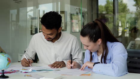 man working with client in a travel agency