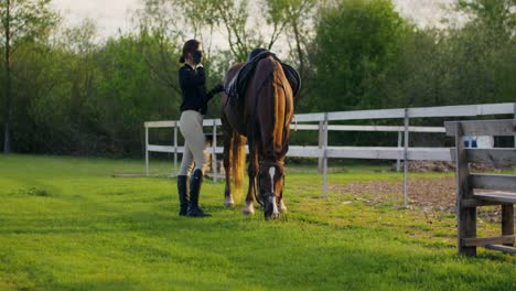 woman preparing a horse for a ride