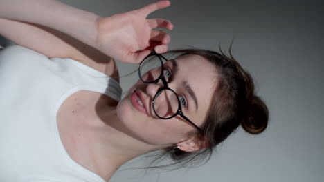 portrait of pretty young lady in tank top and glasses