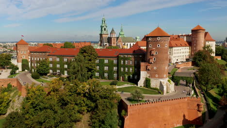 Drone-footage-of-Wawel-Royal-Castle-with-tourists,-Krakow,-Poland