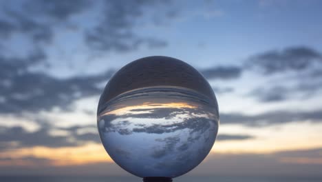 magic sunset view on the beach in a crystal ball.
