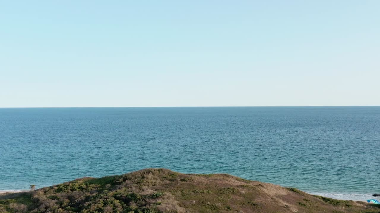 Coastal Landscape with Ocean, Dunes, and People on the Beach