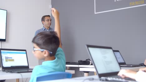 school teacher and children discussing task