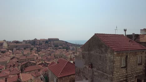 The-sweeping-panorama-captures-the-rooftops-of-Dubrovnik,-the-sea,-and-the-houses,-embodying-the-essence-of-coastal-allure-and-architectural-magnificence