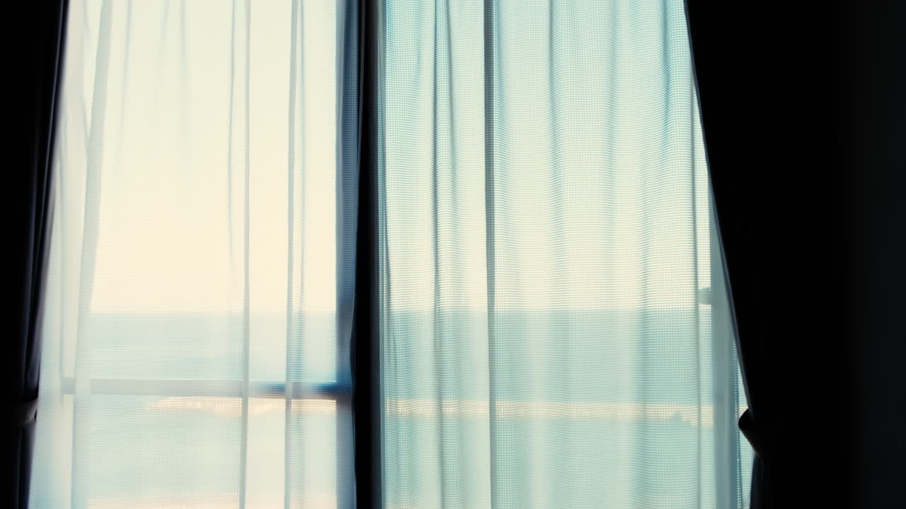 Close up of sunlight through the transparent curtain on the window