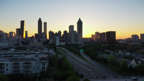 suburb homes with park beside american highway in front of skyline