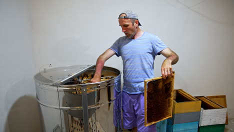 beekeeper extracting honey
