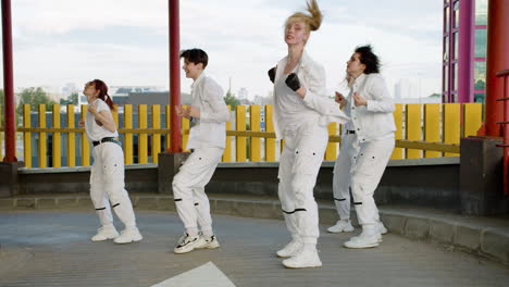 Five-cheerful-woman-in-white-clothing-dancing