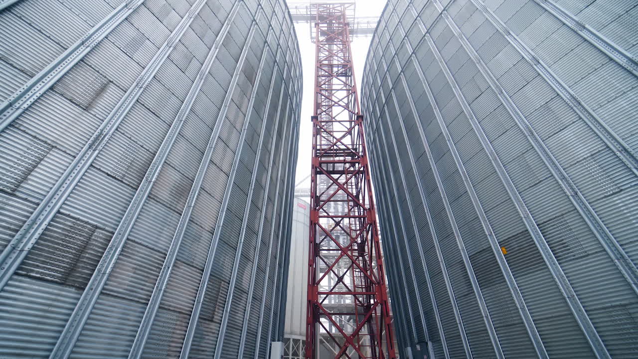 Big steel elevator construction storage. Industrial agriculture farming equipment.