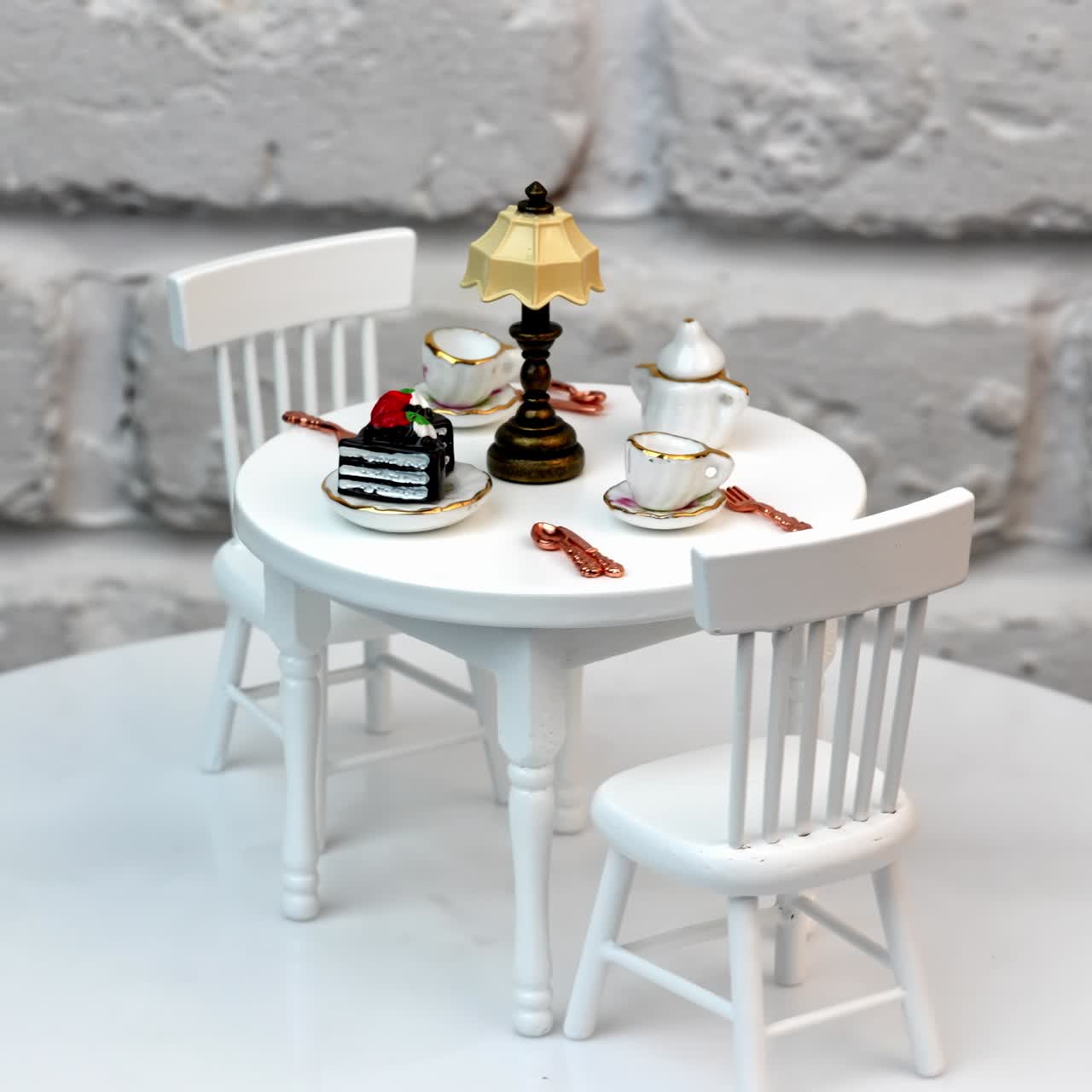 White tiny wooden toy furniture. Small miniature table with chairs for dollhouse