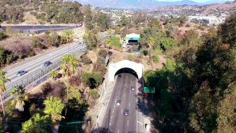 aerial freeway cars travel along the 110 freeway in los angeles through tunnels and towards downtown skyline 5