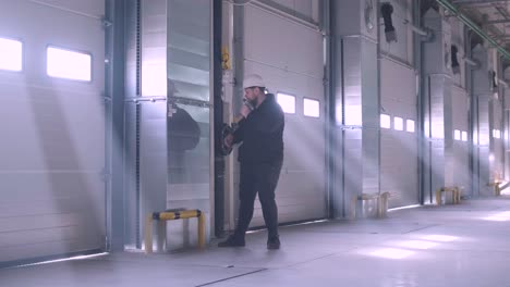 there are automatic gates at a large warehouse. the gates are used for loading cargo from large trucks.