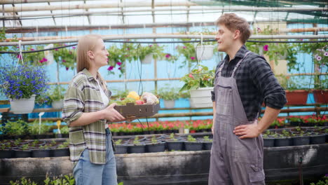 farmer giving harvested vegetables to colleague