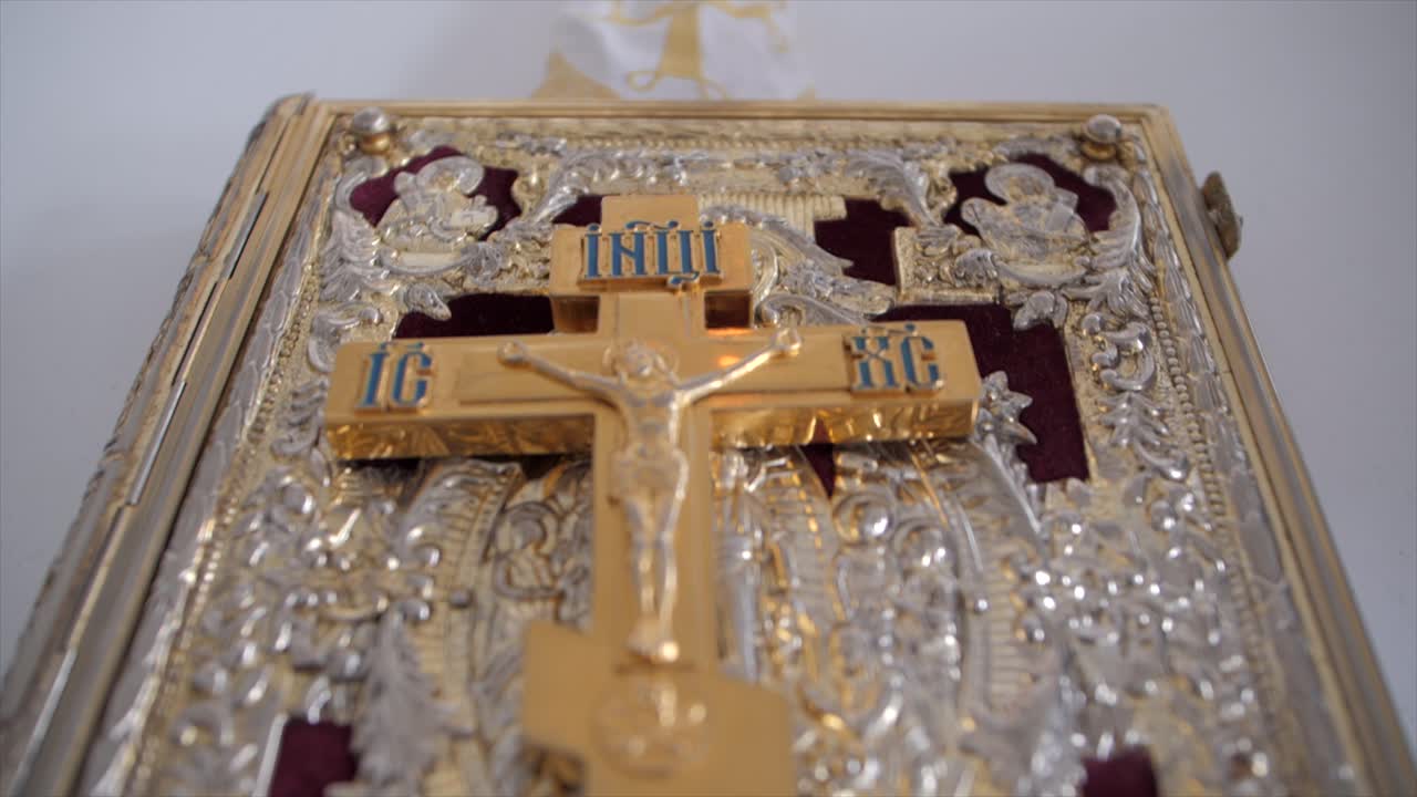 Shot of the golden cross on top of the Holy Gospel , Holy Apostle Book