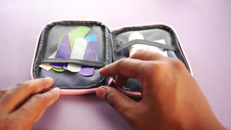 small pink first aid kit with assorted bandages